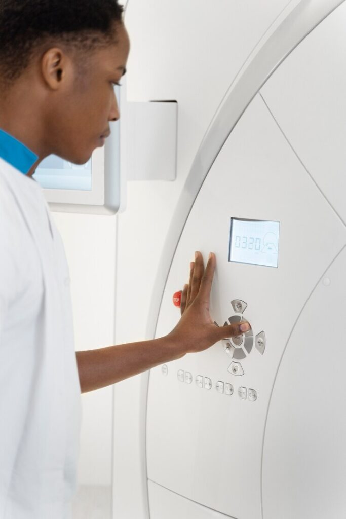 doctor-pressing-ct-scan-machine-buttons_23-2149341545